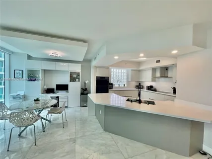 a large kitchen with a table and chairs