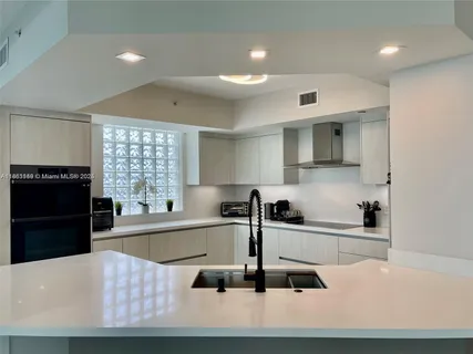 a kitchen with a sink a stove and refrigerator