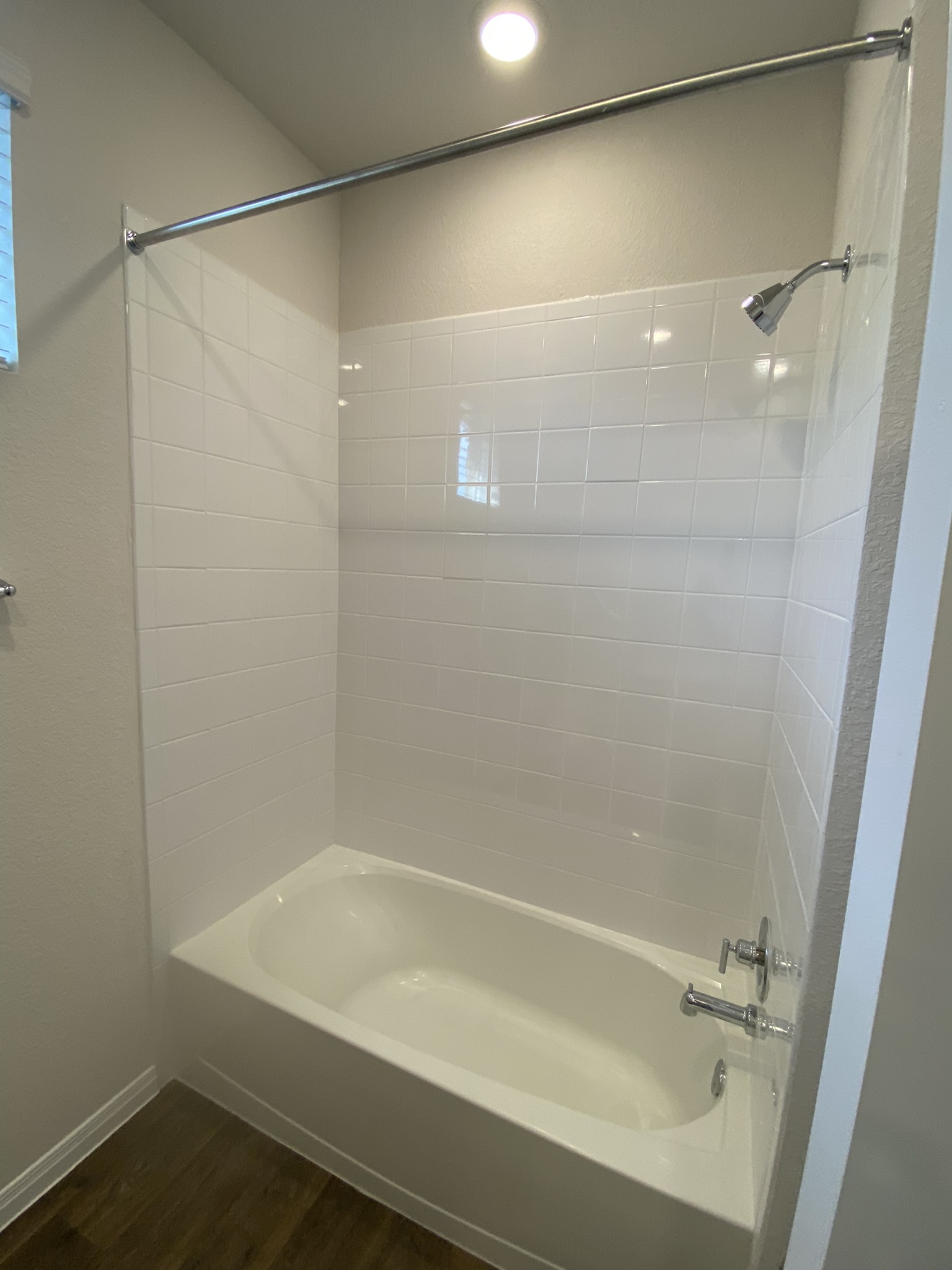 236 Sunniberg Loop Georgetown, TX 78626 - Photo 16 of 22 A classic bathtub paired with tiled surround walls sits beneath overhead recessed lighting.