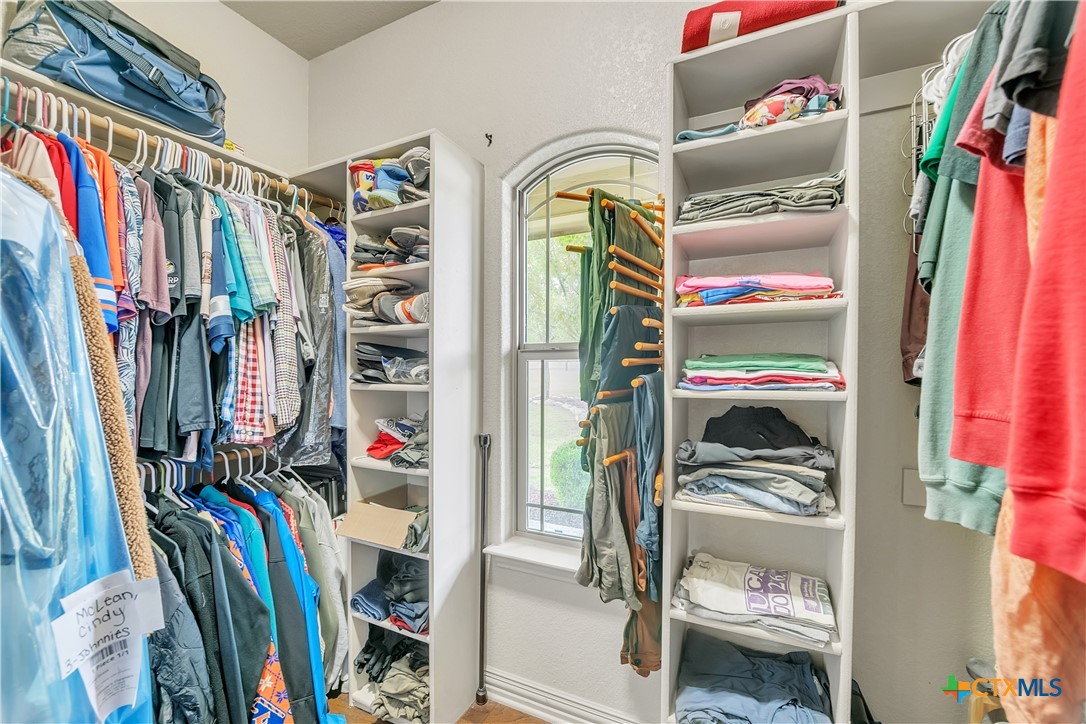 4945 Water Works Road Belton, TX 76513 - Photo 15 of 36 a view of walk in closet with clothes and shoes