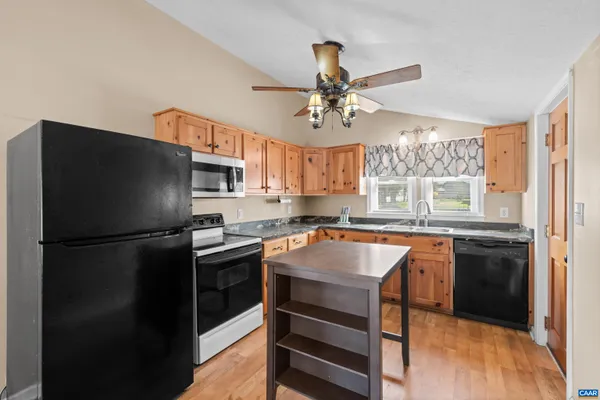 an aerial view of a house with garden space and street view