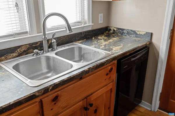 a view of a fountain in front of a house with a big yard