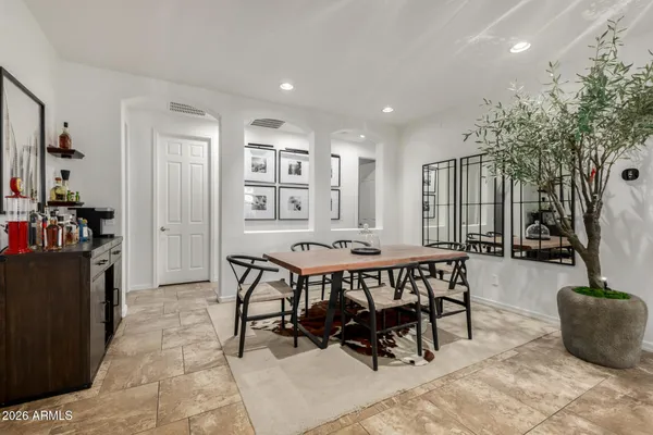 a view of a dining room with furniture and a floor to ceiling window