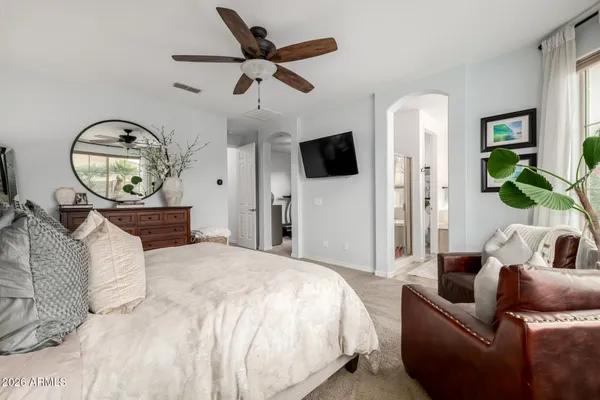 a bed room with a bed a flat screen tv and a couch