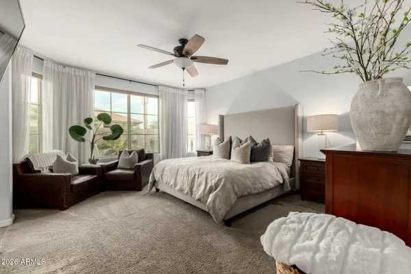 a spacious bedroom with a bed and a couch