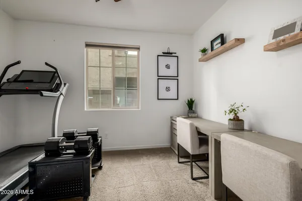 a view of a workspace with furniture and a window
