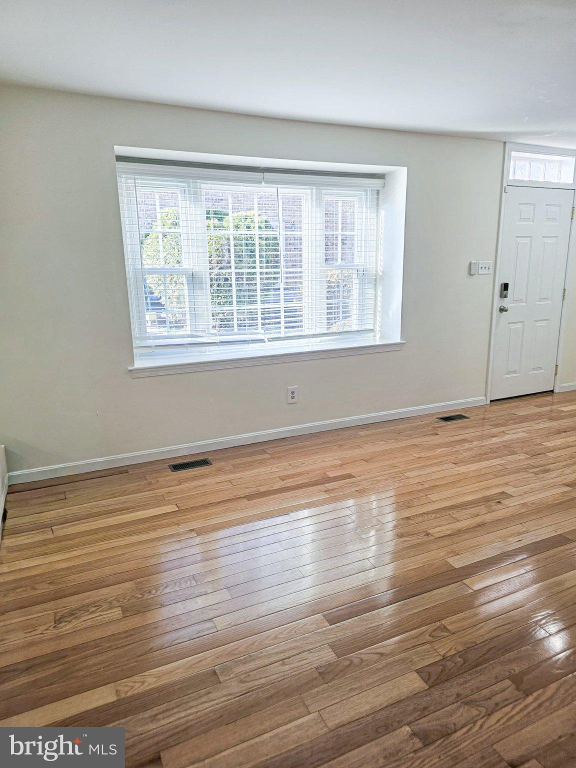 9737 Whiskey Run Laurel, MD 20723 - Photo 4 of 23 a view of empty room with wooden floor and fan