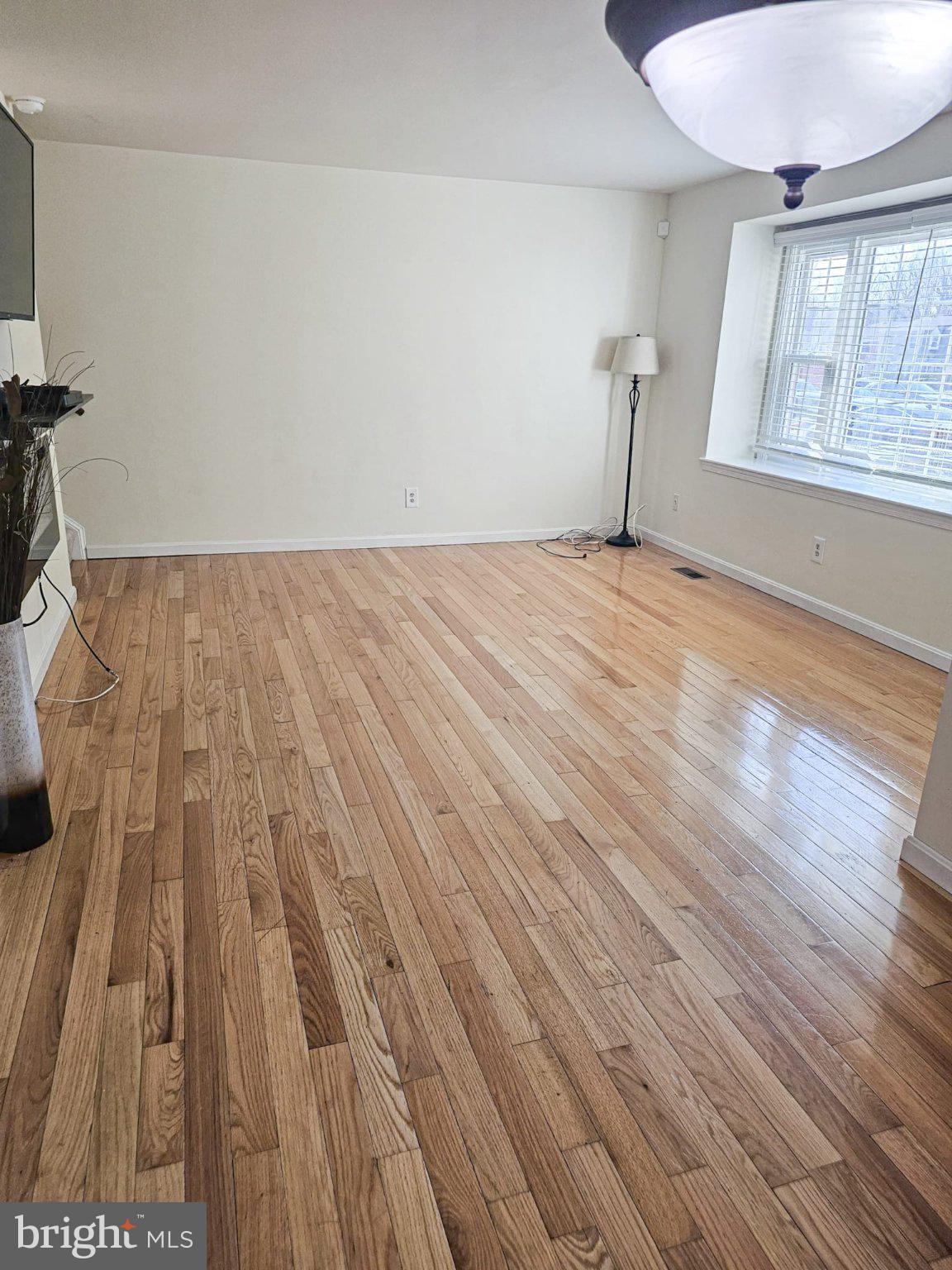 9737 Whiskey Run Laurel, MD 20723 - Photo 6 of 23 a view of wooden floor in an empty room