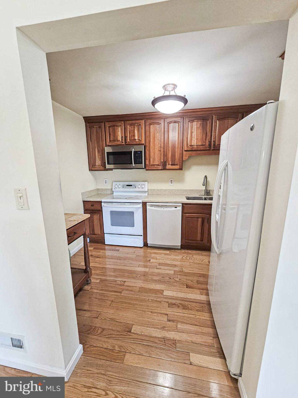 9737 Whiskey Run Laurel, MD 20723 - Photo 7 of 23 a kitchen with stainless steel appliances a refrigerator and a sink