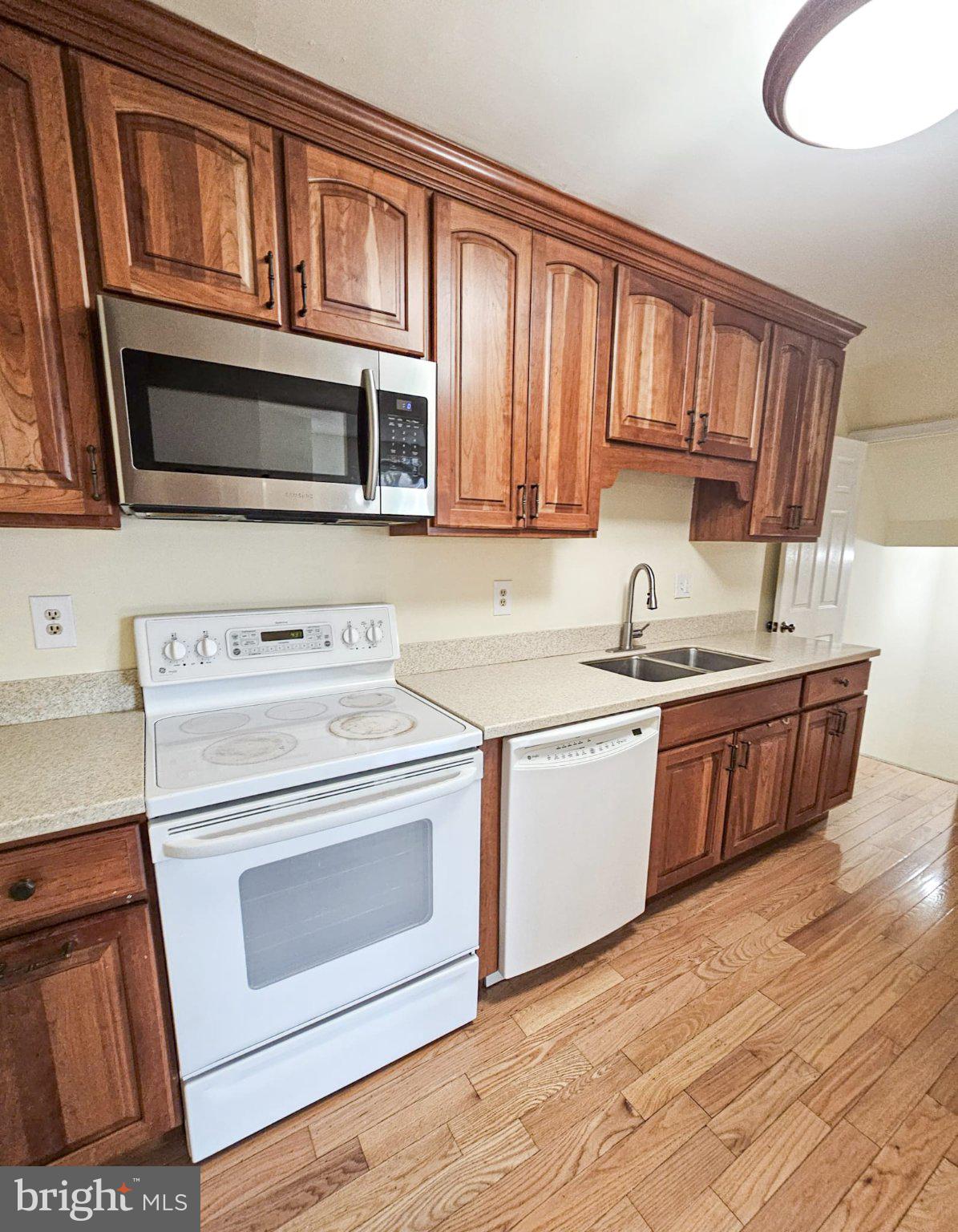 9737 Whiskey Run Laurel, MD 20723 - Photo 9 of 23 a kitchen with stainless steel appliances granite countertop a stove and a sink