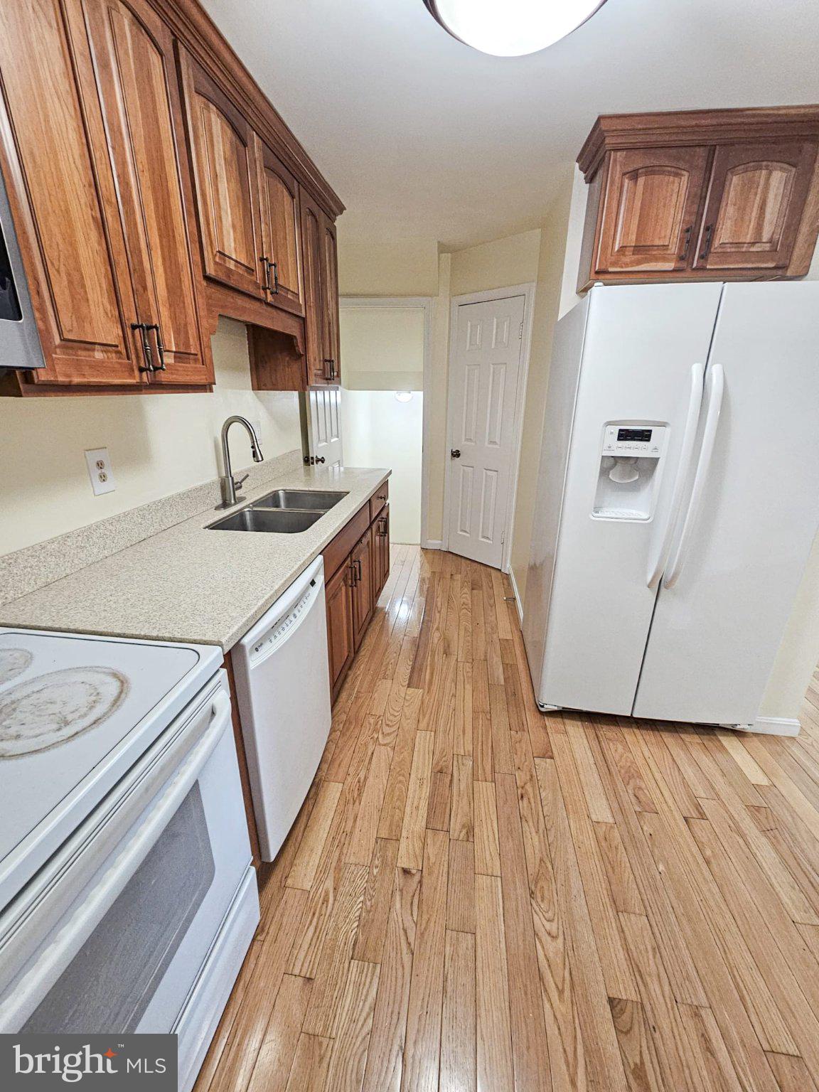 9737 Whiskey Run Laurel, MD 20723 - Photo 10 of 23 a kitchen with a sink a stove and cabinets