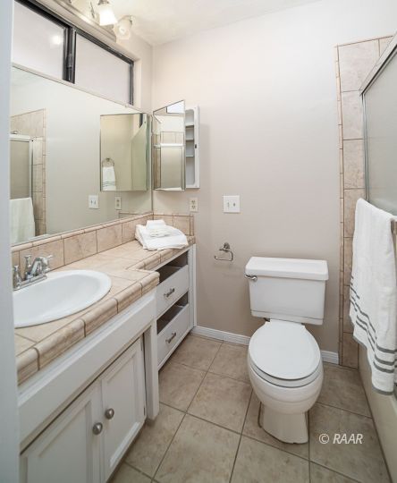 1104 Argus Street Ridgecrest, CA 93555 - Photo 14 of 25 a bathroom with a granite countertop toilet sink and mirror