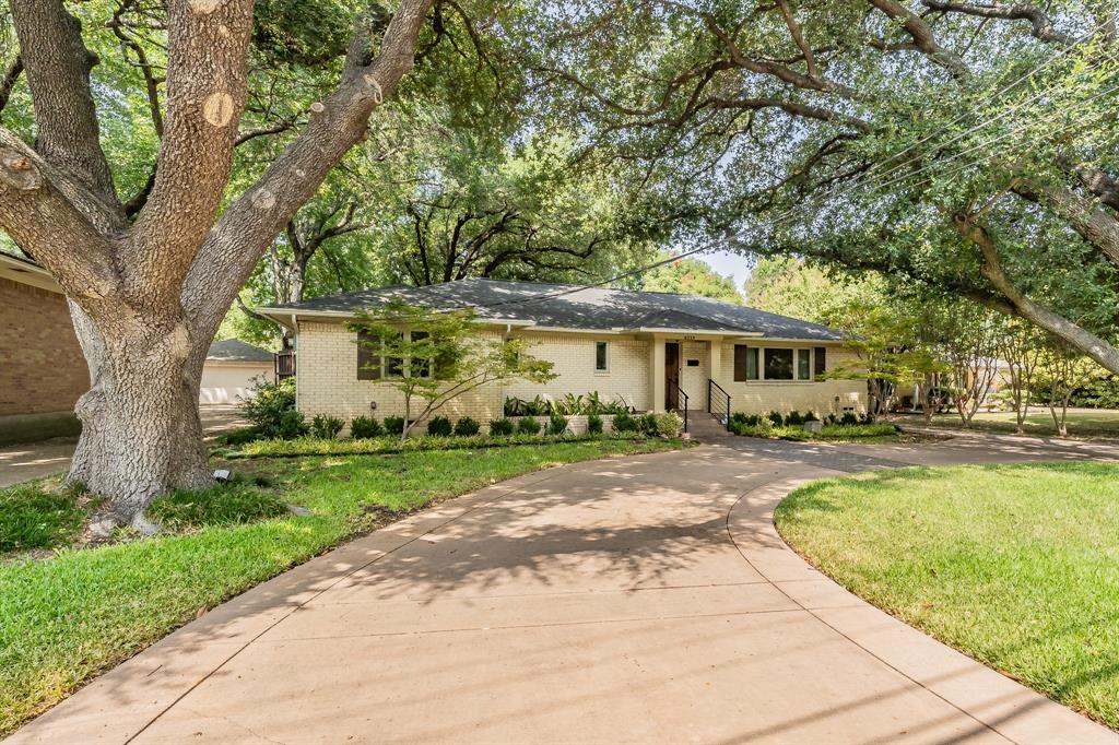 8719 Labron Avenue Dallas, TX 75209 - Photo 1 of 1 a front view of a house with yard and green space