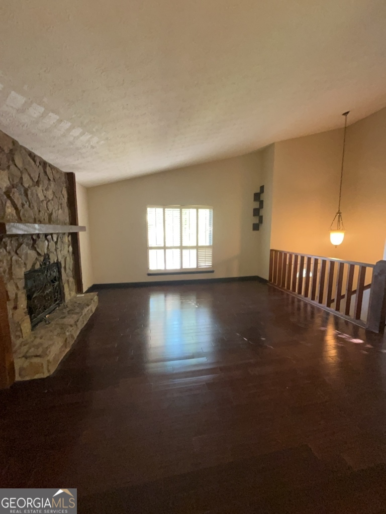 1265 Herrington Road Lawrenceville, GA 30044 - Photo 3 of 52 a view of empty room with wooden floor and fan