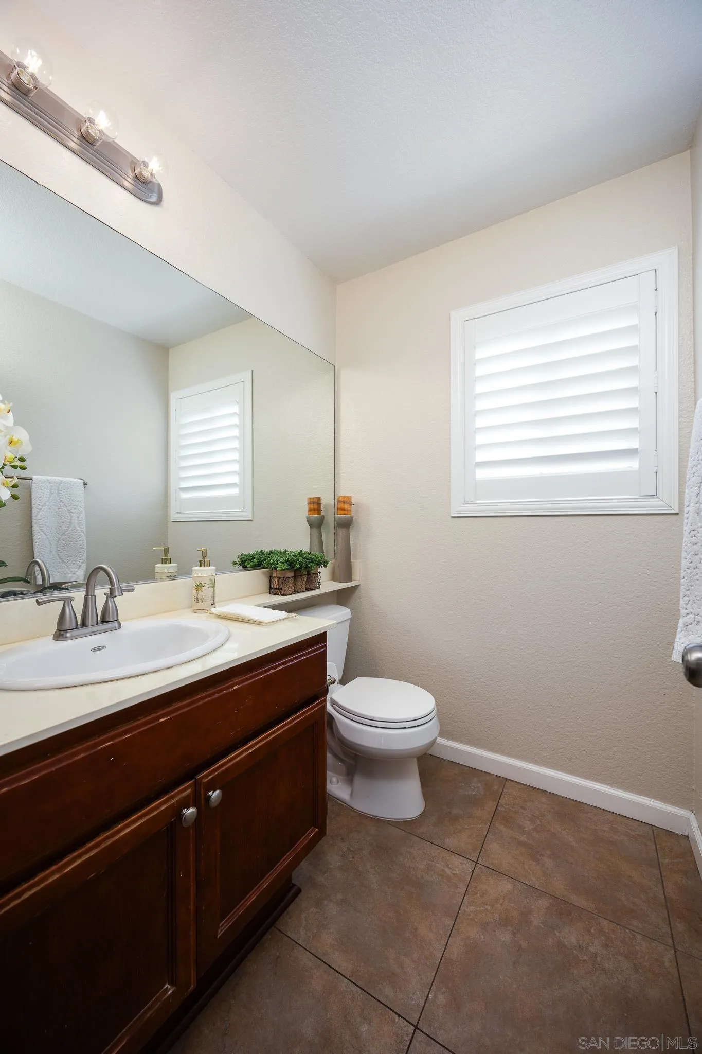 1373 Avenida Azul San Marcos, CA 92069 - Photo 13 of 33 a bathroom with a toilet sink and mirror