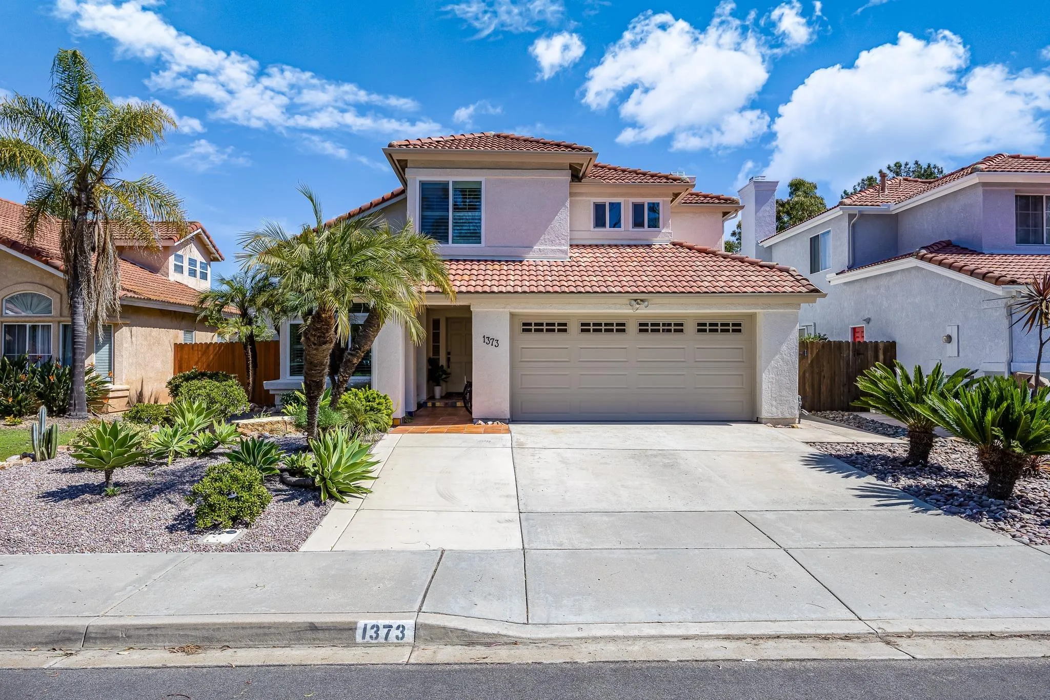1373 Avenida Azul San Marcos, CA 92069 - Photo 25 of 33 a front view of a house with a yard and garage