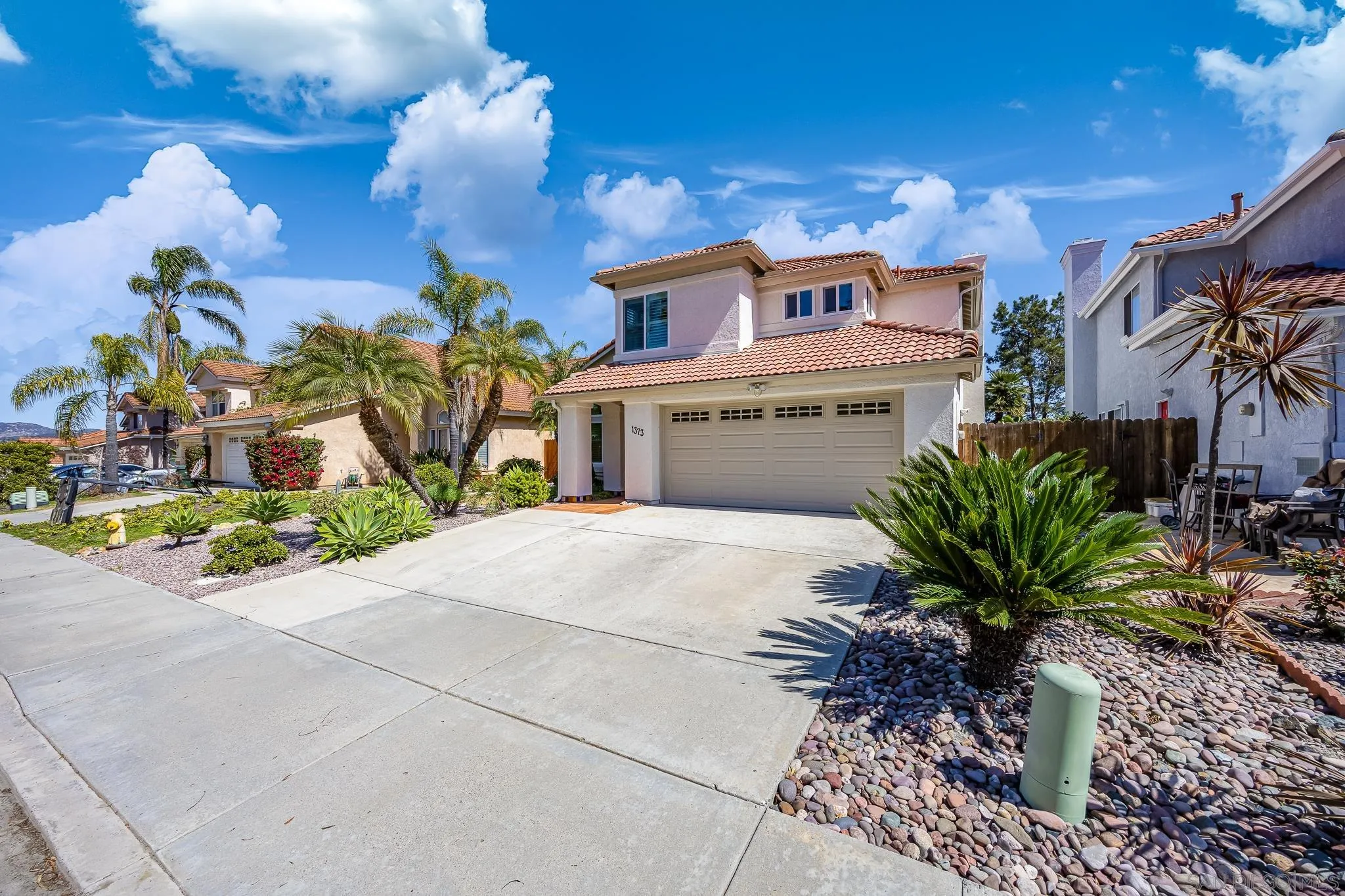 1373 Avenida Azul San Marcos, CA 92069 - Photo 3 of 33 a potted plant sitting in front of a building