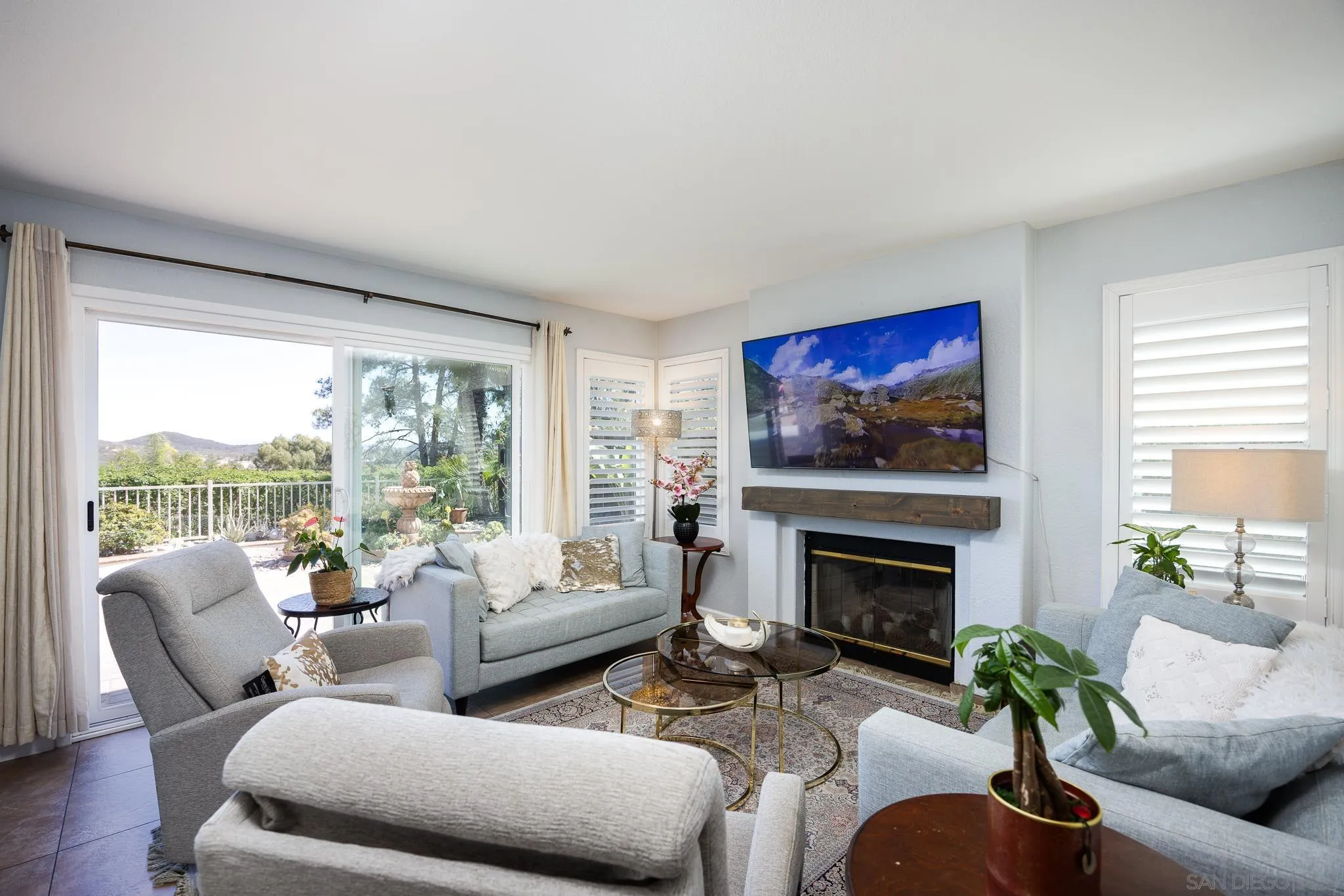 1373 Avenida Azul San Marcos, CA 92069 - Photo 8 of 33 a living room with furniture a flat screen tv and a fireplace