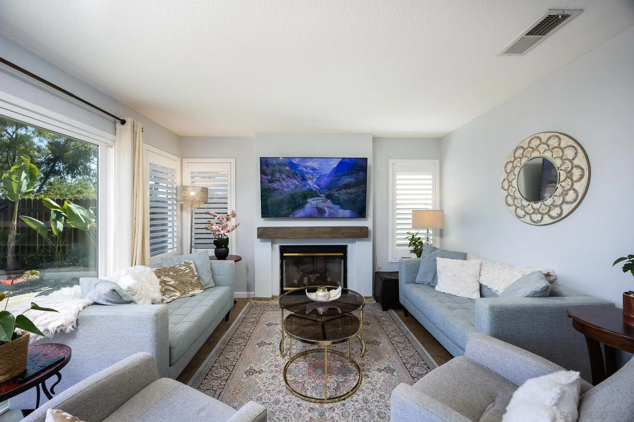 1373 Avenida Azul San Marcos, CA 92069 - Photo 9 of 33 a living room with furniture a rug a fireplace and a large window