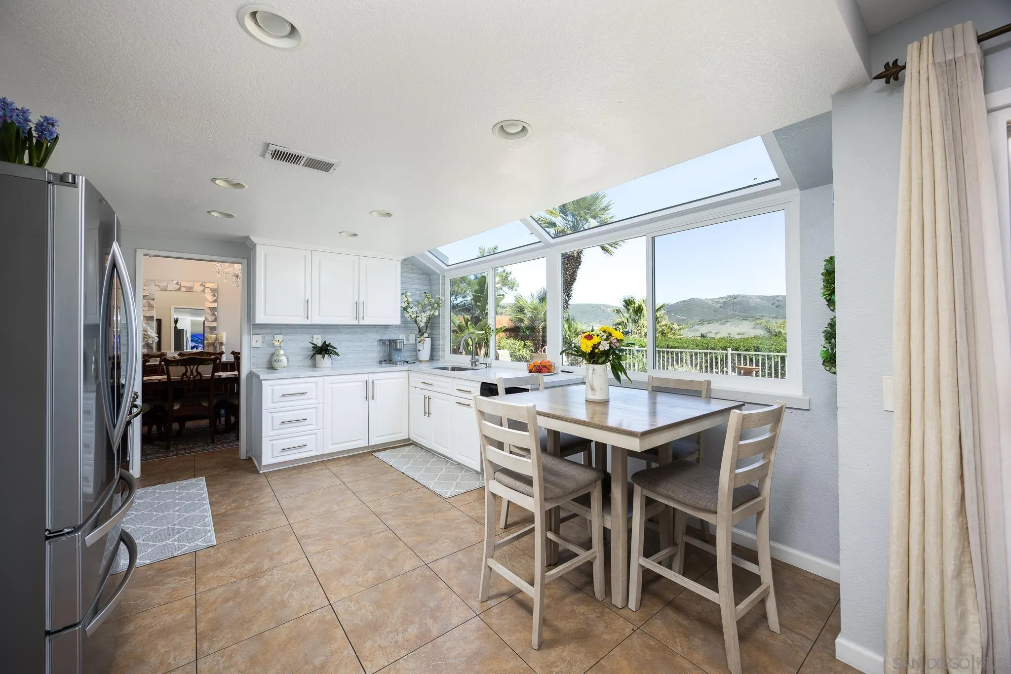 1373 Avenida Azul San Marcos, CA 92069 - Photo 10 of 33 a kitchen with a table and chairs in it