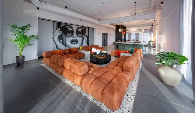 a bed room with furniture and a potted plant