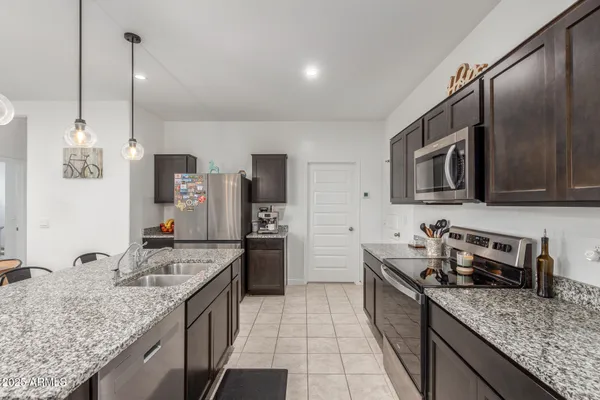 a kitchen with sink cabinets and stainless steel appliances