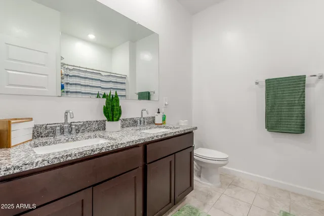 a bathroom with a granite countertop sink a mirror and vanity