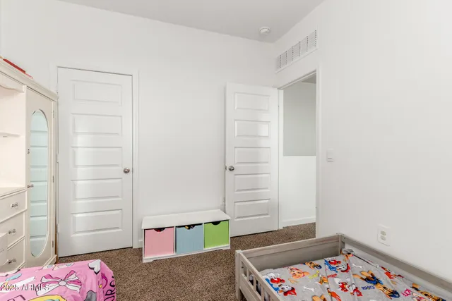 a bedroom with a bed and a dresser