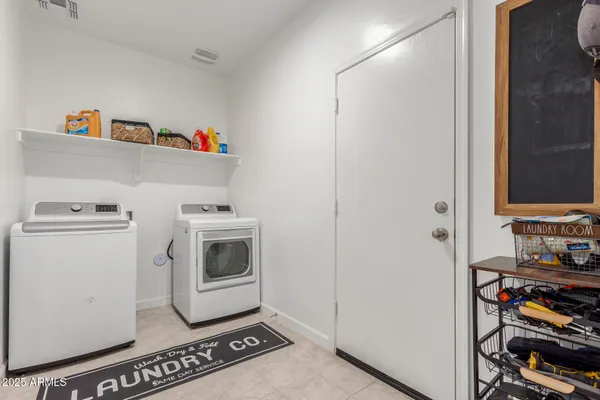 a utility room with closet dryer and washer