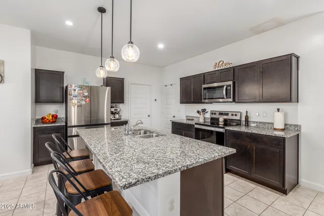 a kitchen with a table chairs microwave and cabinets