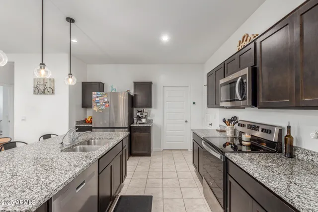 a kitchen with sink cabinets and stainless steel appliances