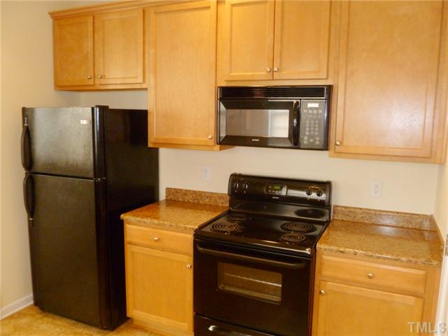 6040 Ladish Lane Raleigh, NC 27610 - Photo 11 of 21 a kitchen with a stove and a refrigerator