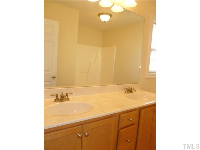 6040 Ladish Lane Raleigh, NC 27610 - Photo 17 of 21 a bathroom with a sink and a mirror