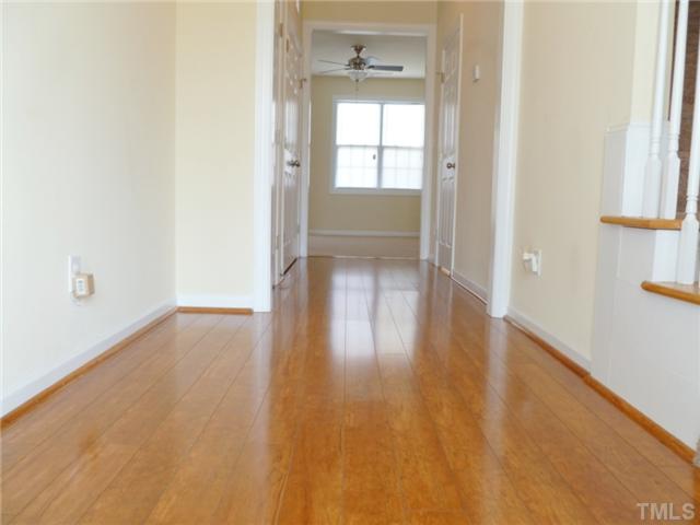 6040 Ladish Lane Raleigh, NC 27610 - Photo 3 of 21 a view of empty room with wooden floor and fan