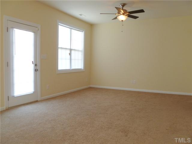 6040 Ladish Lane Raleigh, NC 27610 - Photo 5 of 21 an empty room with a window and a fan