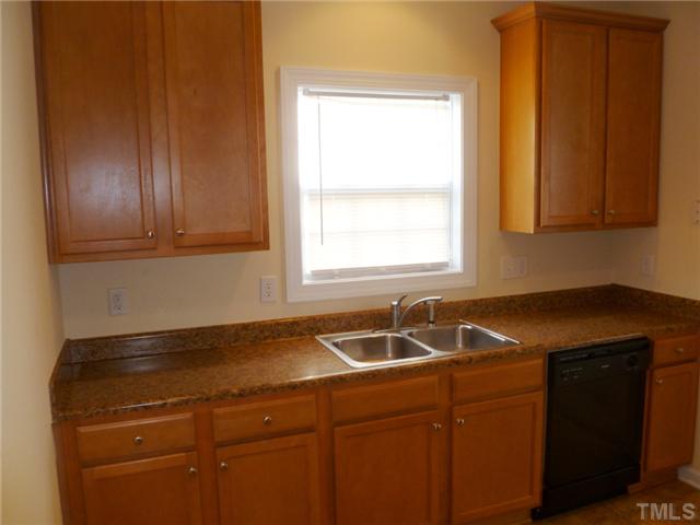 6040 Ladish Lane Raleigh, NC 27610 - Photo 9 of 21 a kitchen with a sink and cabinets