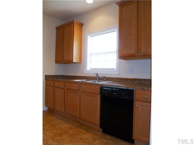 6040 Ladish Lane Raleigh, NC 27610 - Photo 10 of 21 a kitchen with granite countertop a sink and a stove