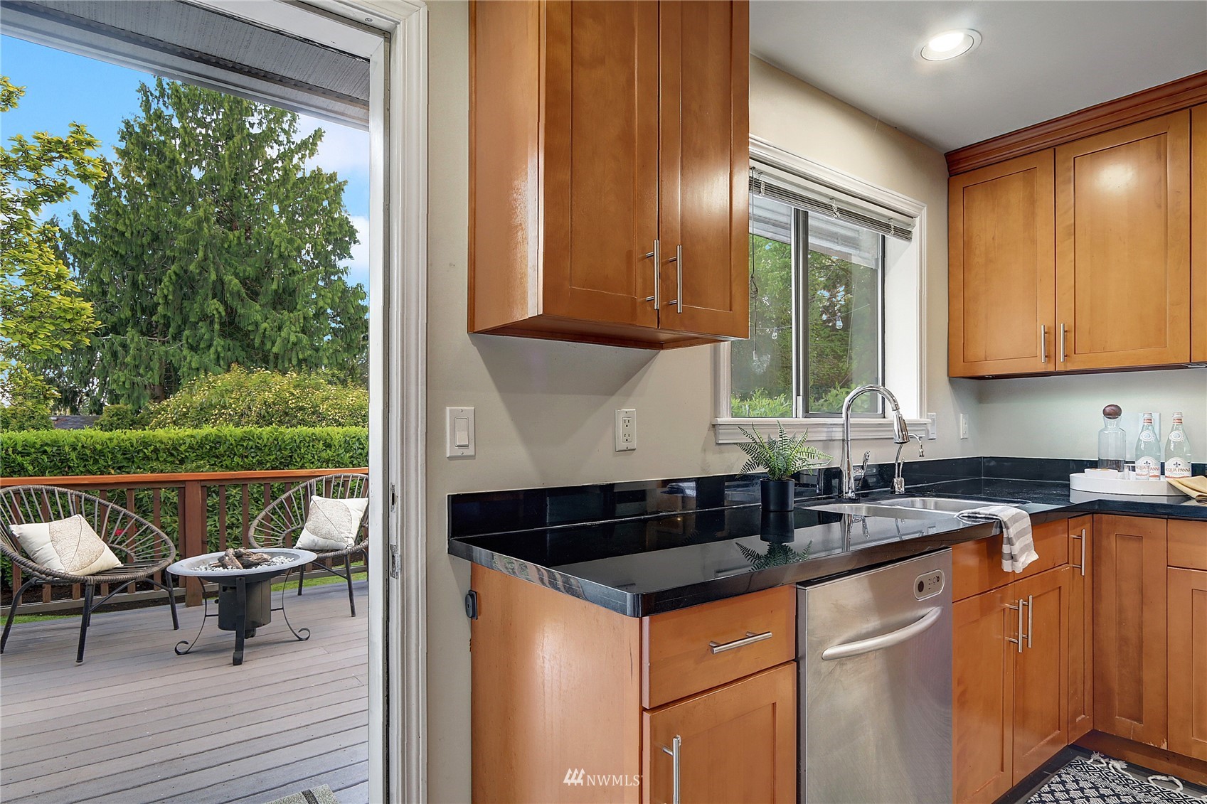 5217 South Myrtle Street Seattle, WA 98118 - Photo 13 of 30 a kitchen with granite countertop a stove a sink and wooden cabinets