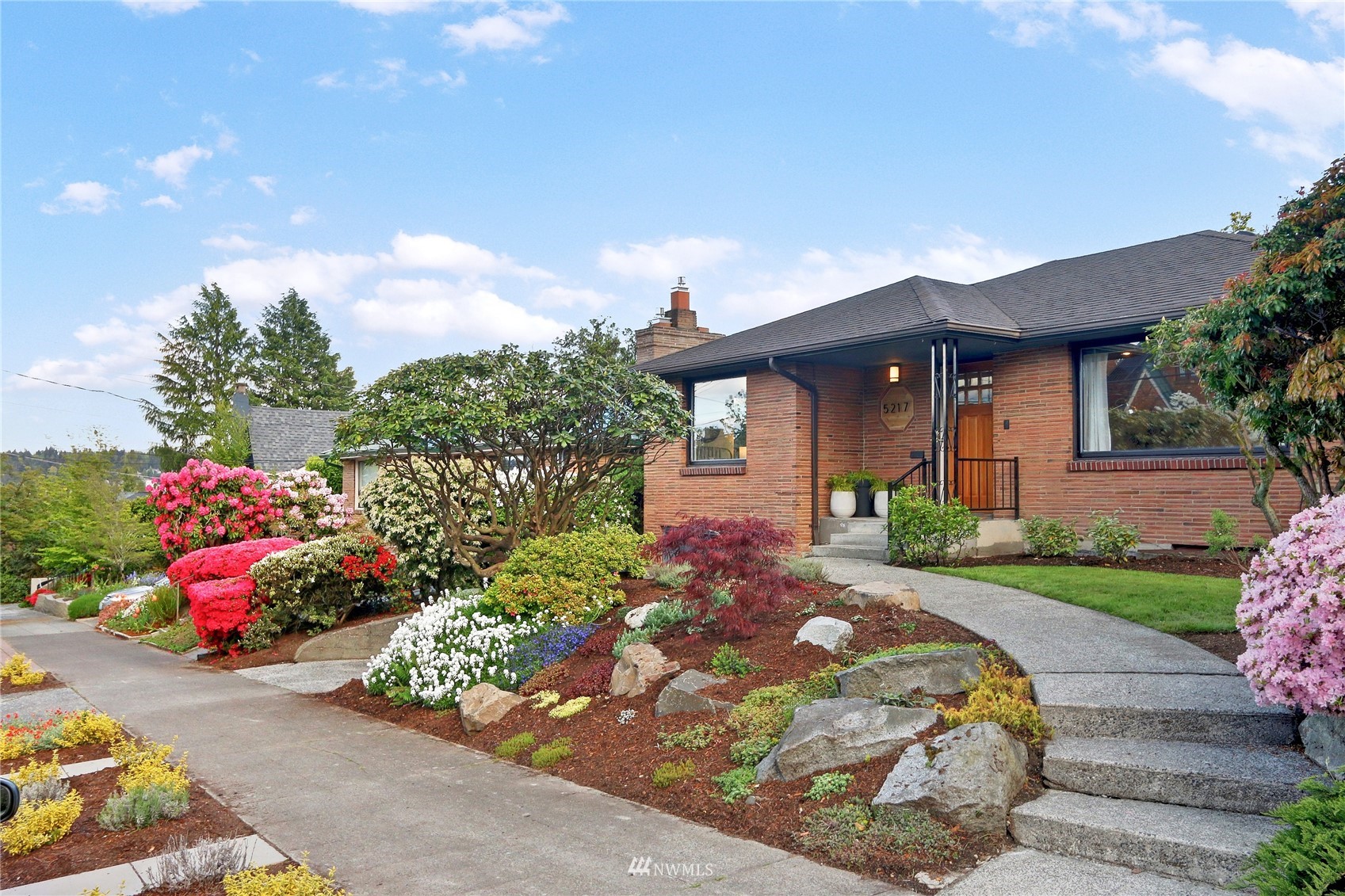 5217 South Myrtle Street Seattle, WA 98118 - Photo 2 of 30 a front view of a house with a yard and garage