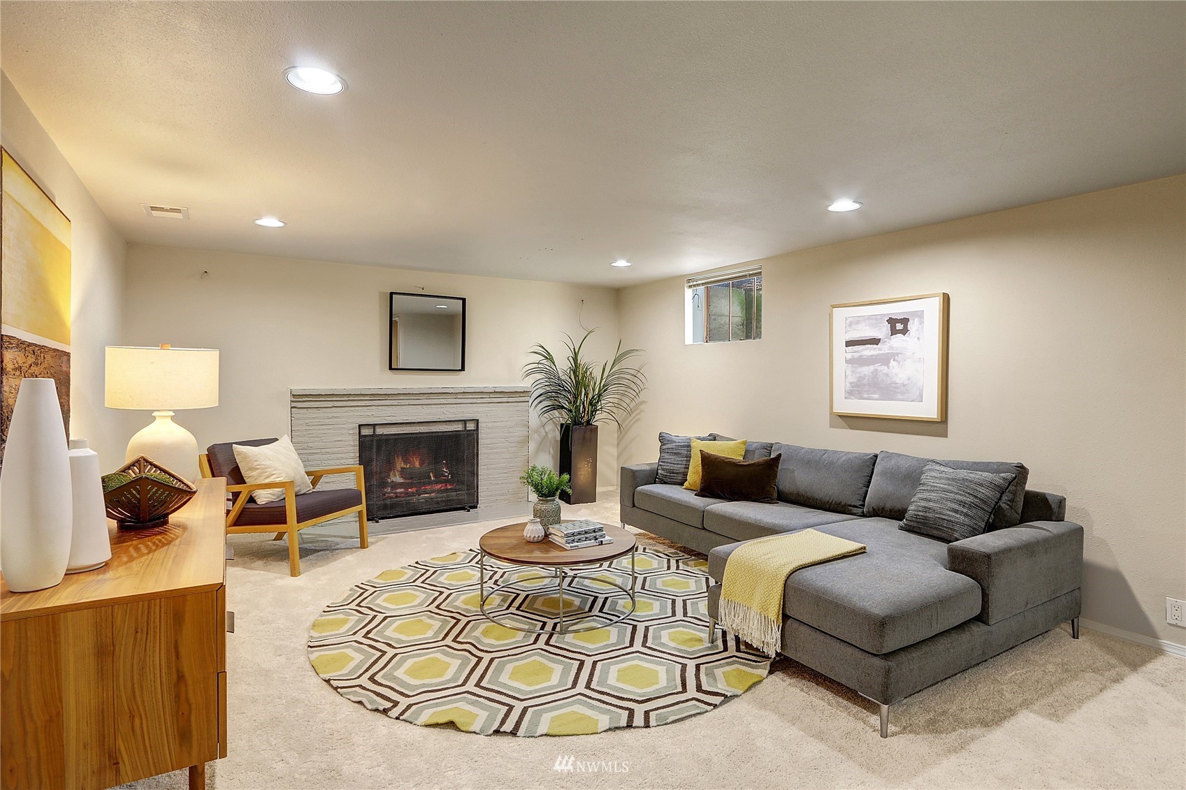 5217 South Myrtle Street Seattle, WA 98118 - Photo 23 of 30 a living room with furniture a fireplace and a flat screen tv