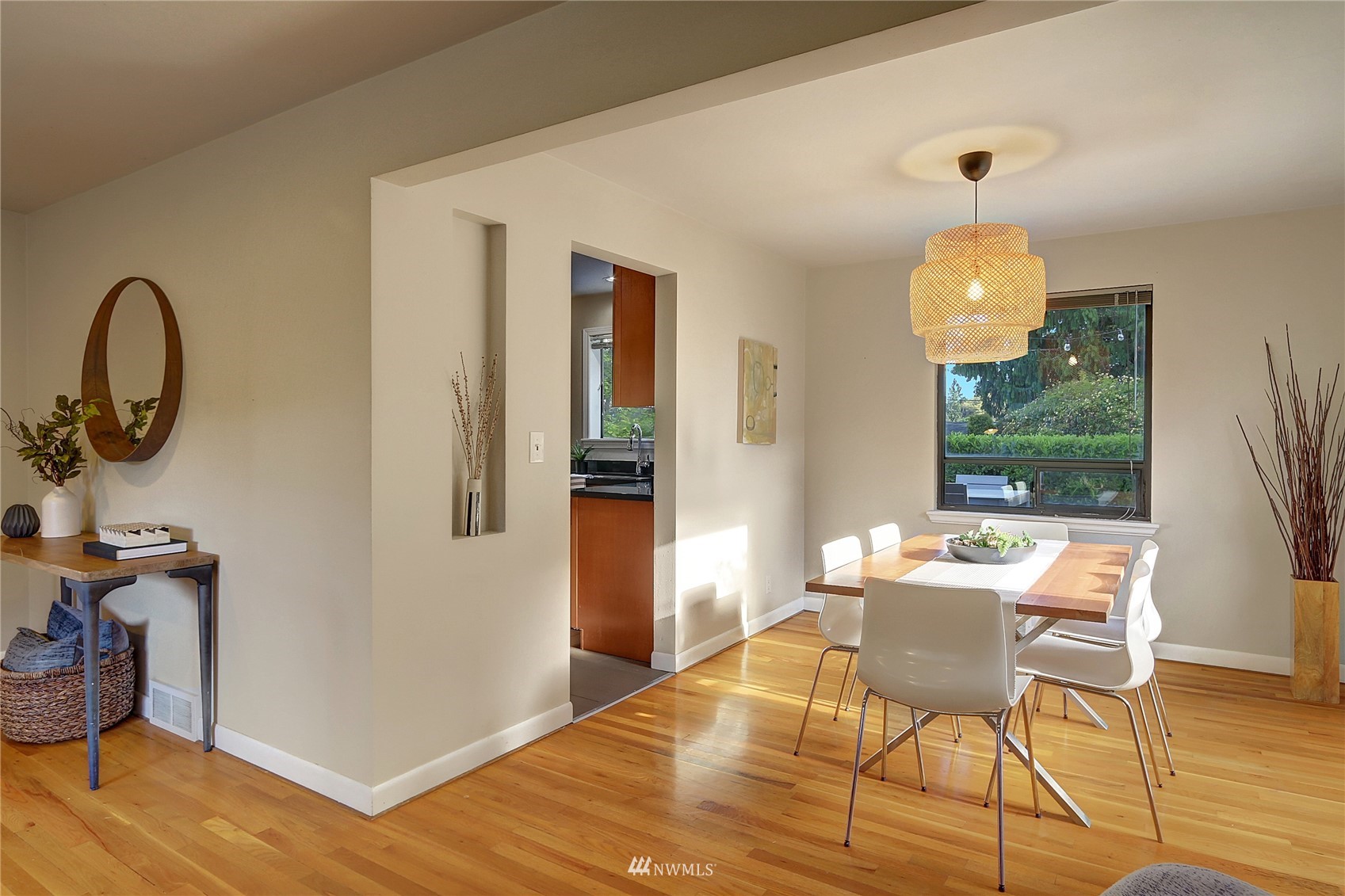 5217 South Myrtle Street Seattle, WA 98118 - Photo 8 of 30 a dining room with chandelier fan and wooden floor