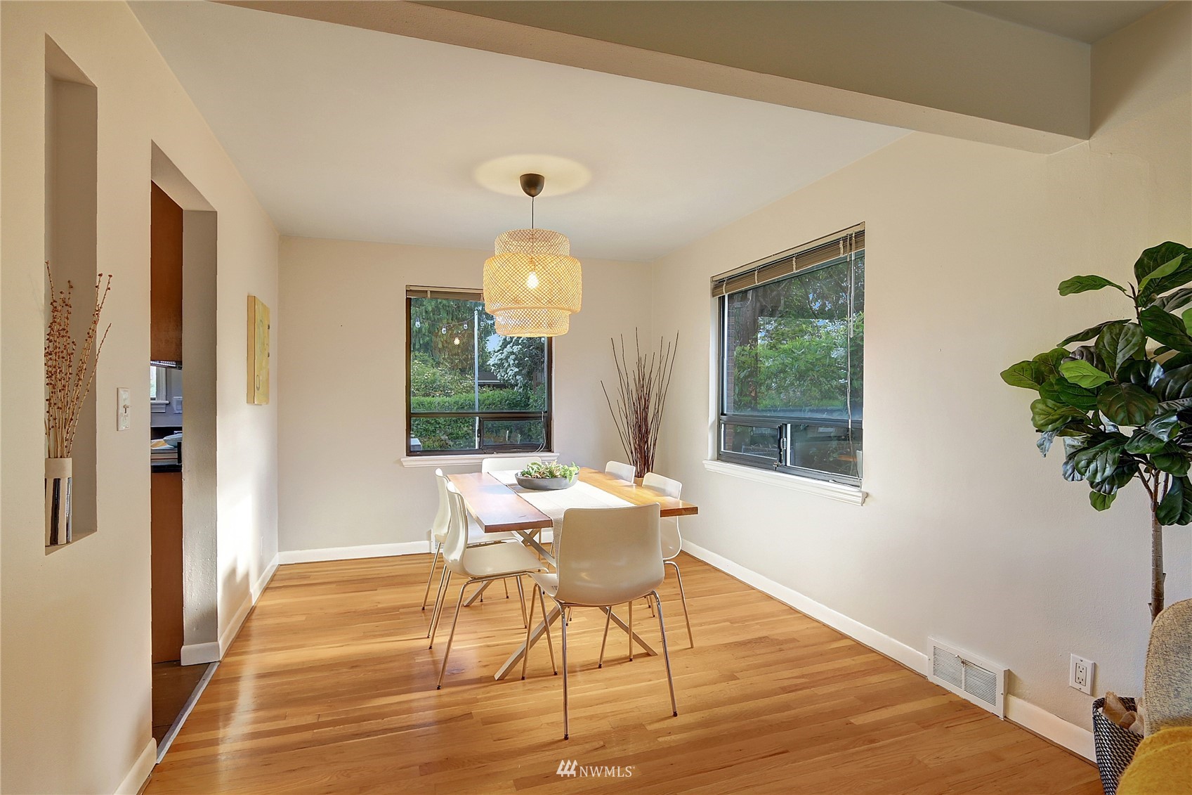 5217 South Myrtle Street Seattle, WA 98118 - Photo 9 of 30 a work room with wooden floor and a potted plant