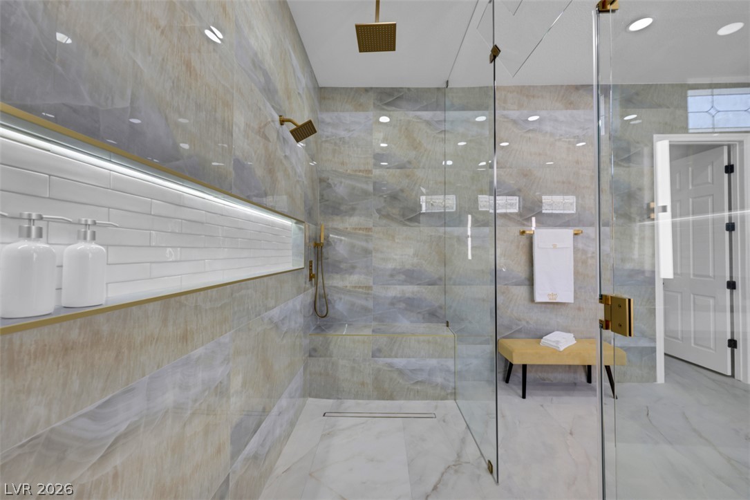 5015 Rivedro Street Las Vegas, NV 89135 - Photo 17 of 91 Luxurious walk-in shower features dual shower heads and sleek, modern tile.