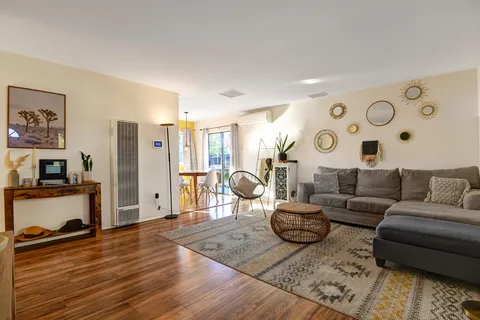 a living room with furniture and wooden floor