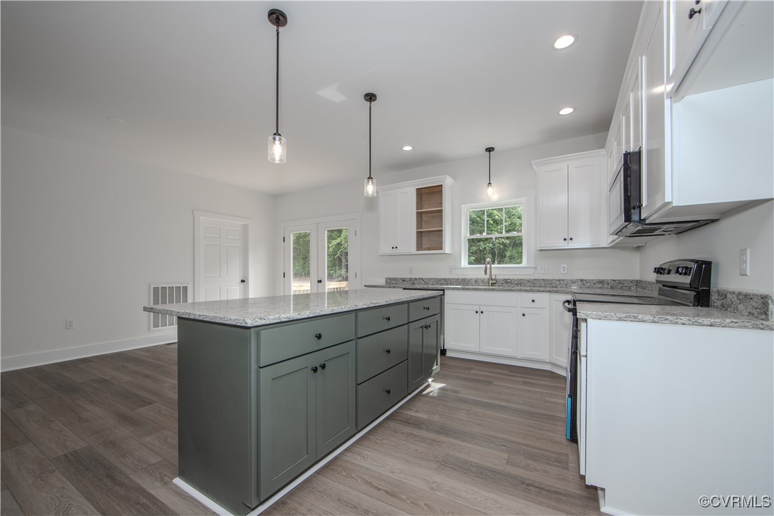 10500 Cross County Road Mineral, VA 23117 - Photo 12 of 27 a kitchen with stainless steel appliances granite countertop a sink a stove a refrigerator and white cabinets with wooden floor