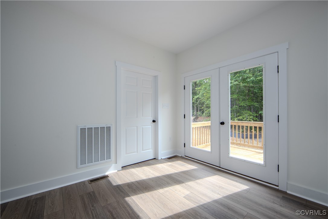 10500 Cross County Road Mineral, VA 23117 - Photo 13 of 27 a view of an empty room with wooden floor and a window