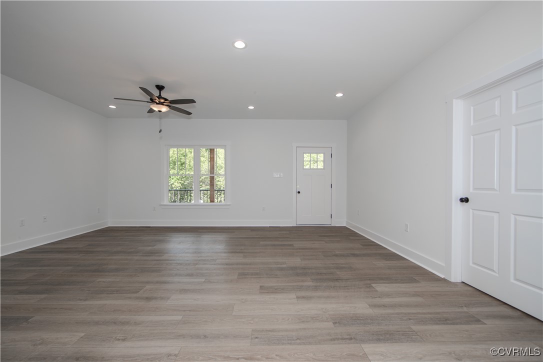10500 Cross County Road Mineral, VA 23117 - Photo 7 of 27 an empty room with wooden floor chandelier fan and windows