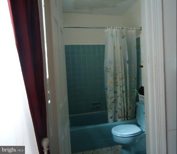 13209 Glenhill Road Silver Spring, MD 20904 - Photo 14 of 19 a bathroom with a shower a toilet and sink