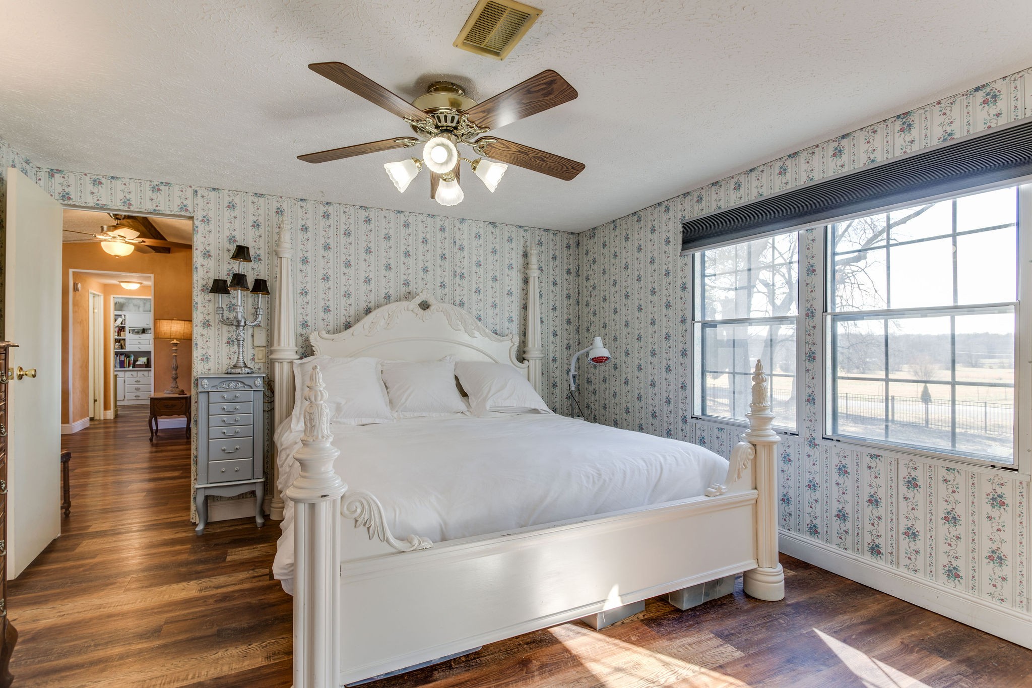 148 Stacy Road Manchester, TN 37355 - Photo 29 of 57 a spacious bedroom with a bed and a chandelier