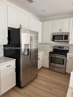 a kitchen with a refrigerator stove and microwave